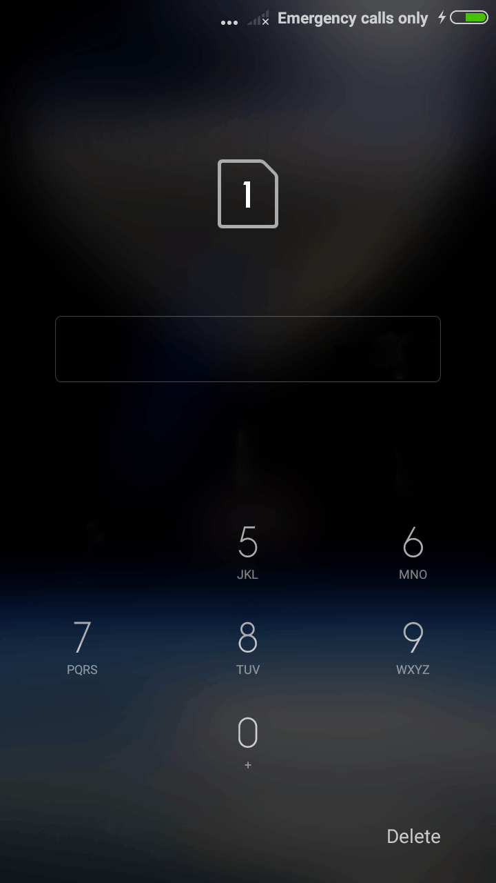 The screen to unlock the phone. The emergency call button is in the bottom left hand of the corner and delete key in the bottom right of the screen. The keypad is just above the emergency and delete button. The keypad ends about half way up the phone screen. The edit box enter pin is just above the keypad. the unlock sim button is to the right of the edit box