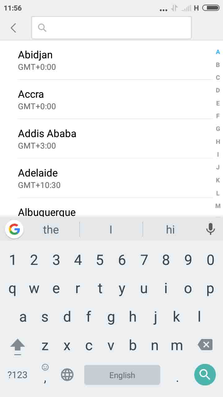 there is a search bar at the top of the screen about 1,5cm from the top. it stretches from about 1,5cm from the left edge of the phone to 1,5cm from the right edge of the phone. next to the search bar is a more options bar. Below this is a list of places in different time zones alphabetically. about half way down the screen there is a virtual keyboard with the search button in the bottom right of the screen about 1,5cm from the bottom edge and 1cm from the right edge. 